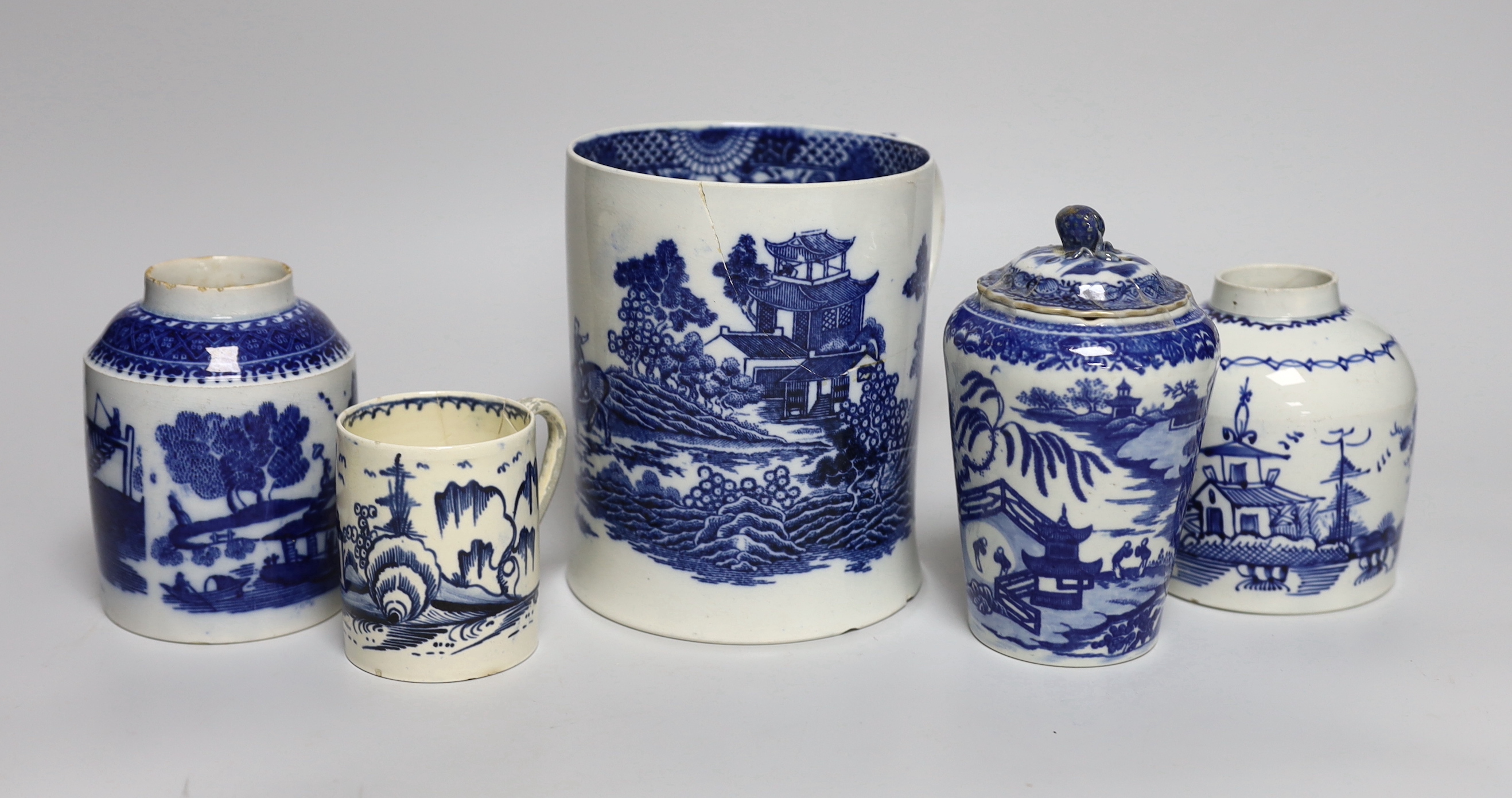 A group of mixed late 18th/early 19th century blue and white pearlware etc. tea canisters and mugs, the largest 14cm high
